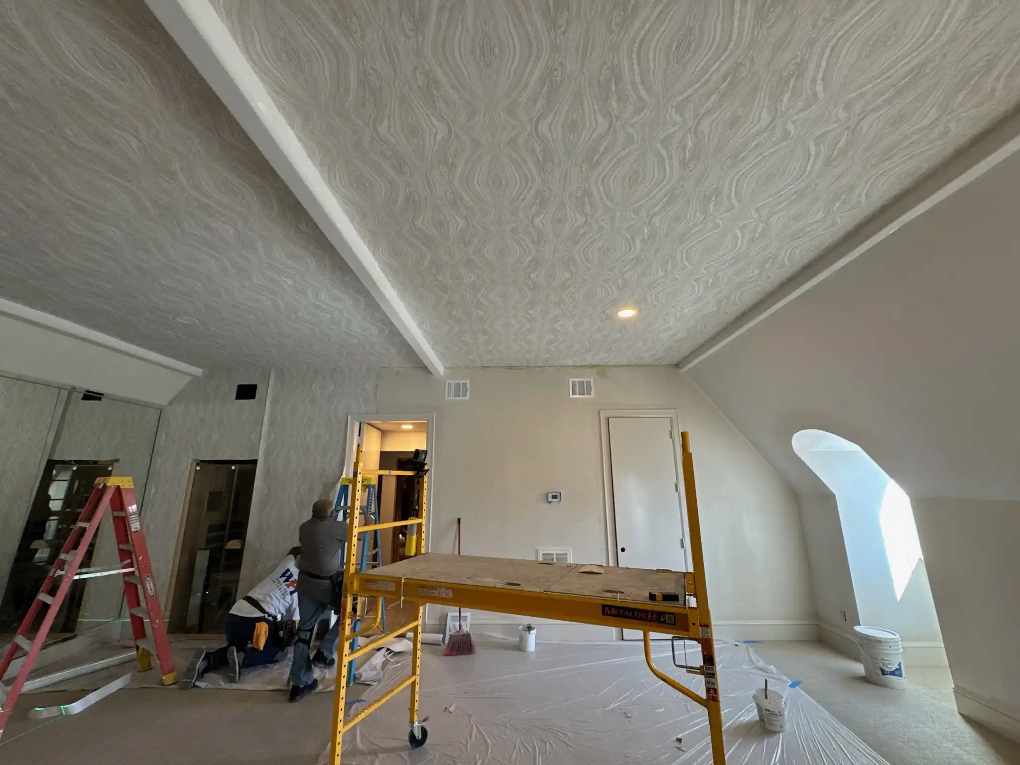 Professional wallpaper removal protecting wall surface
